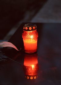 Close-up of illuminated tea light candles on table