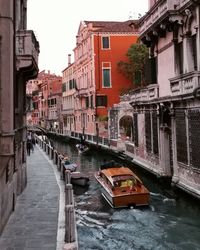 Bridge over canal amidst buildings in city