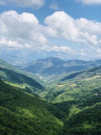 Scenic view of valley and mountains against sky