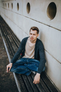 Young man smoking cigarette outdoors