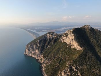 Scenic view of sea and mountains against sky