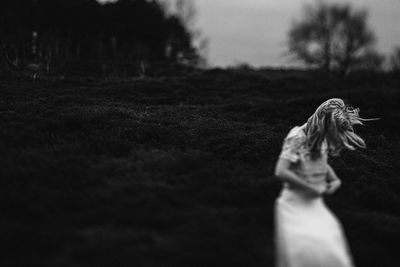 Close-up of woman on field against sky