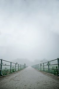 Road by bridge against sky