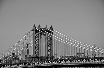 Low angle view of manhattan bridge and city against sky