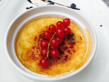 High angle view of fresh cherries served with creme brulee in bowl