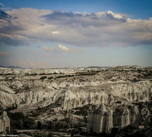 Scenic view of landscape against cloudy sky