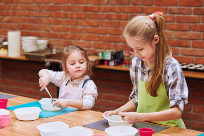 Girls preparing food at table