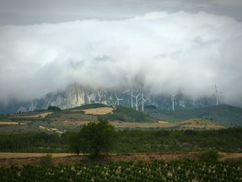 Scenic view of field and mountains against sky