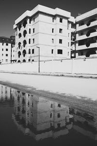 Reflection of built structure in swimming pool