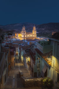 High angle view of illuminated buildings in city at night