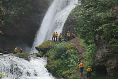 Panoramic view of people by waterfall