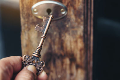 Close-up of person holding chain