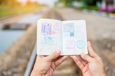 Close-up of hands holding passport