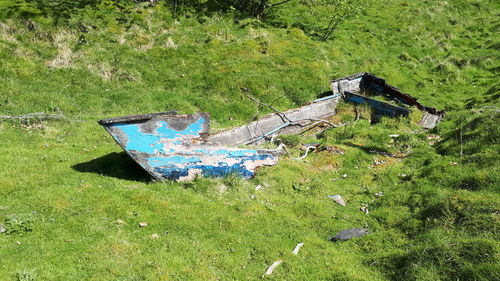 High angle view of abandoned car on field