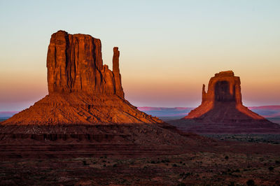 Rock formations in desert during sunset