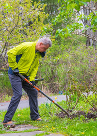 Side view of man working in forest