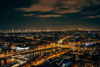High angle view of illuminated city against sky at night