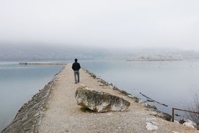 Man on beach against sky
