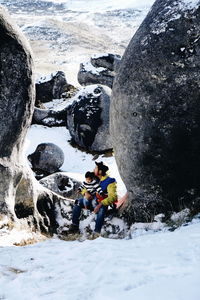 People on rocks during winter