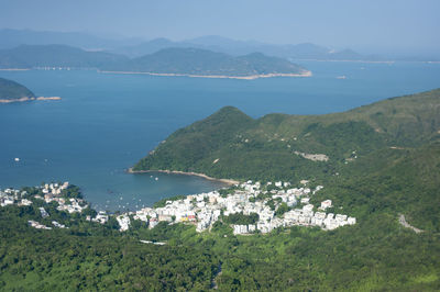 High angle view of sea and mountains against sky