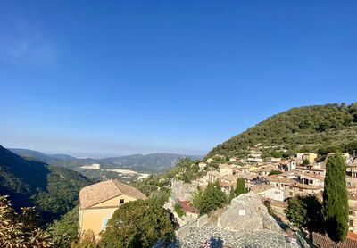 High angle view of townscape against clear blue sky