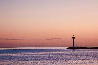 Scenic view of sea against orange sky