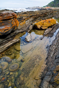 Aerial view of rocks on beach against sky