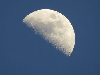 Low angle view of moon against blue sky