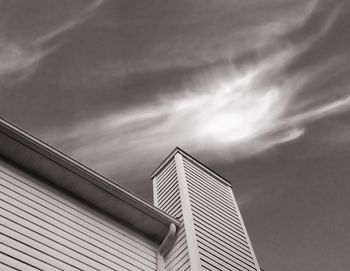 Low angle view of building against cloudy sky