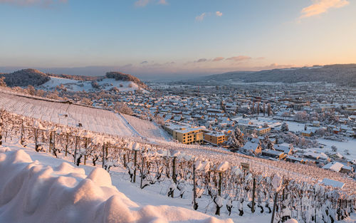 Scenic view of snow covered mountains against sky during sunset