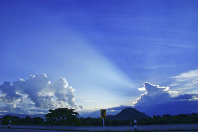 Scenic view of silhouette trees against blue sky