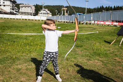 Full length of boy standing on grass