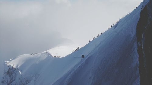 Scenic view of mountains against sky during winter