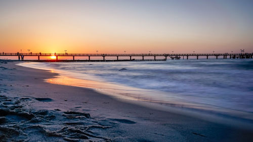 Scenic view of beach against sky during sunset