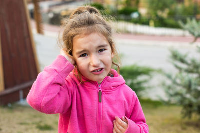 Close-up portrait of cute girl while standing outdoors