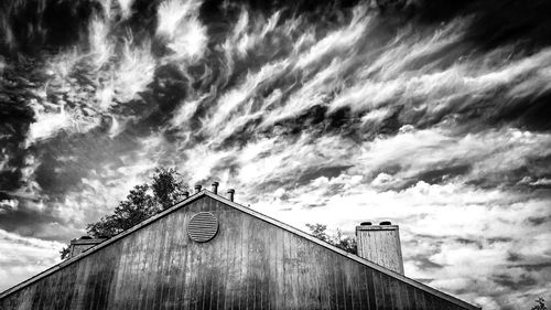 Low angle view of building against cloudy sky