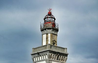 Low angle view of tower against cloudy sky