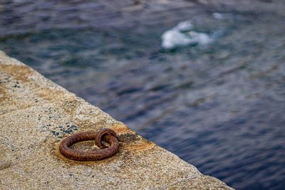 Close-up of rusty metal on rock