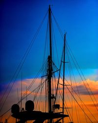 Low angle view of silhouette sailboat against sky during sunset