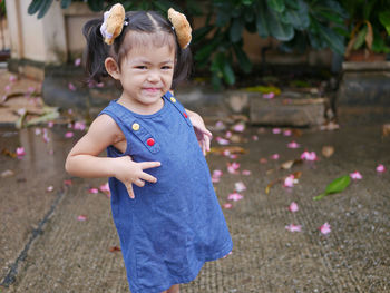 Adorable baby girl, 40 months old, smiling and making cute pose for outdoor photo shoot