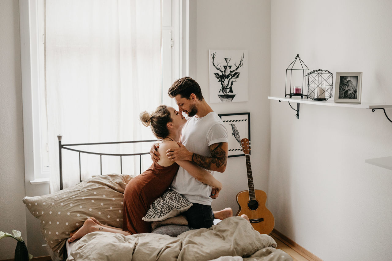 WOMAN WITH ARMS RAISED ON BED