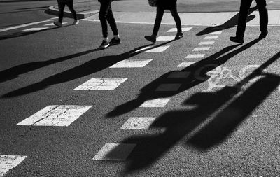 Low section of people walking on road