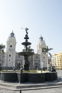 Buildings in city against clear sky