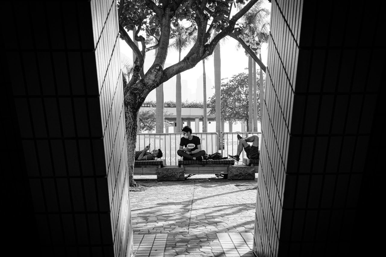 PEOPLE ON FOOTPATH AMIDST BUILDINGS IN CITY