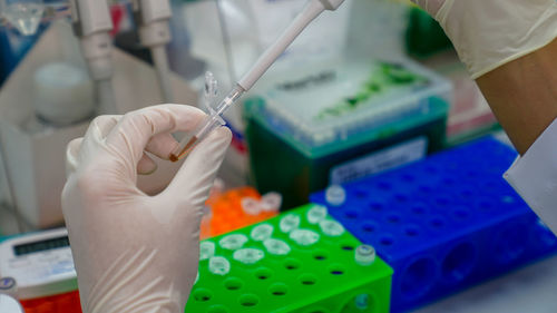 Midsection of person working with multi colored umbrella
