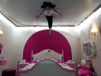 Rear view of a woman jumping at home