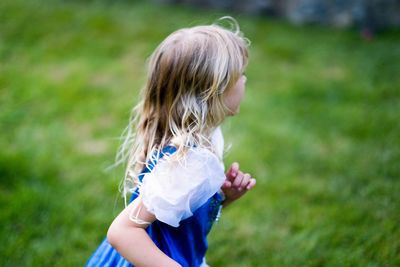 Rear view of girl on grassy field