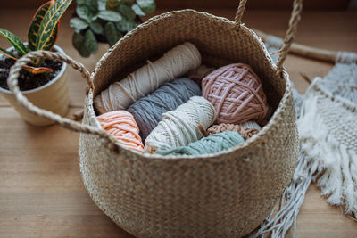 Flatley of products from macrame threads on a wooden background