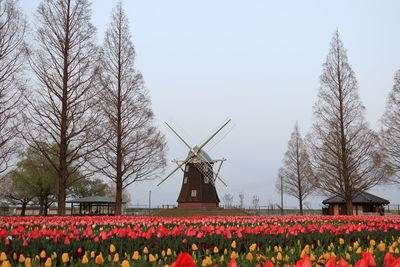 Low angle view of traditional windmill against clear sky