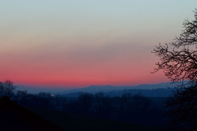 Scenic view of silhouette landscape against romantic sky at sunset